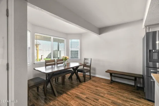 a view of a dining room with furniture and wooden floor