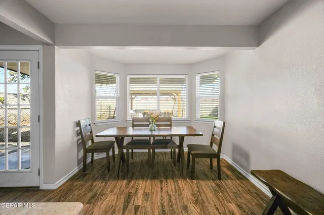 a kitchen with stainless steel appliances kitchen island granite countertop a refrigerator and a stove top oven