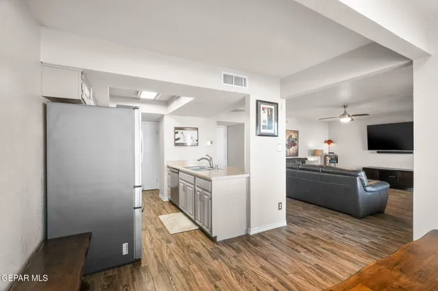 a kitchen with granite countertop a refrigerator and a sink