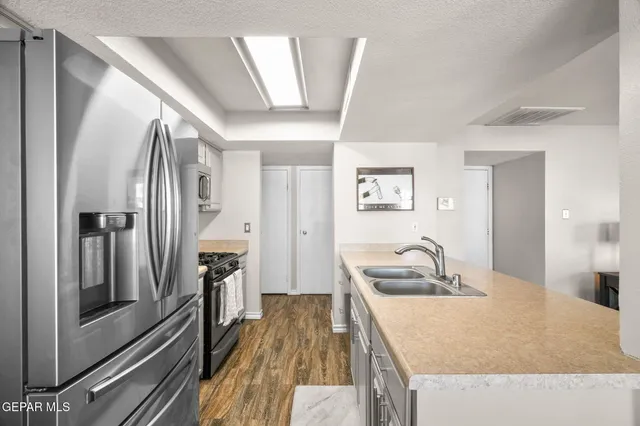 a kitchen with stainless steel appliances granite countertop a stove and a sink