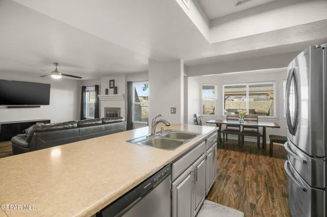 a kitchen with stainless steel appliances granite countertop a stove refrigerator and microwave