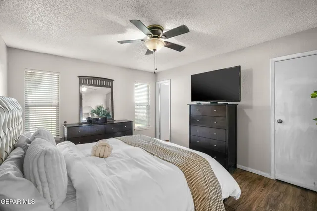 a bedroom with bed and a chandelier
