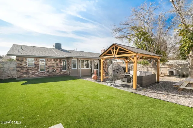 a view of a patio with table and chairs potted plants