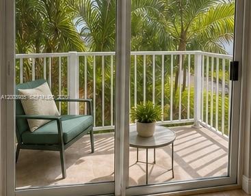 948 Southwest 3rd Street, Unit 205 Miami, FL 33130 - Photo 8 of 11 a view of a chair and tables in the balcony