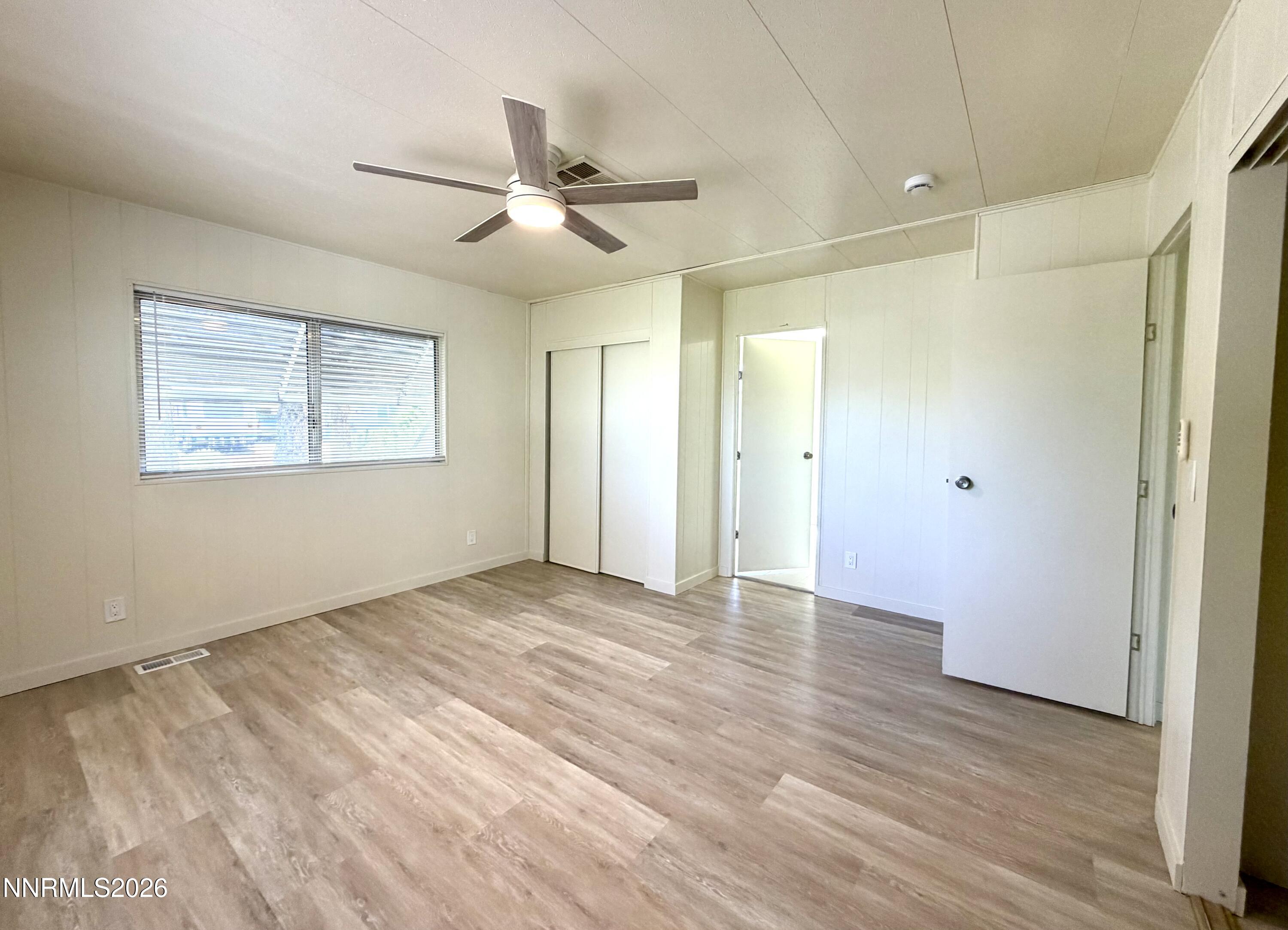 330 Taurus Circle Reno, NV 89521 - Photo 19 of 27 a view of an empty room with wooden floor and a window