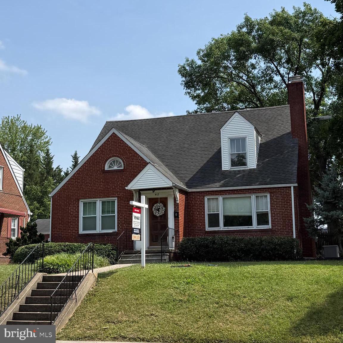 412 Carroll Parkway Frederick, MD 21701 - Photo 3 of 11 a front view of a house with a garden