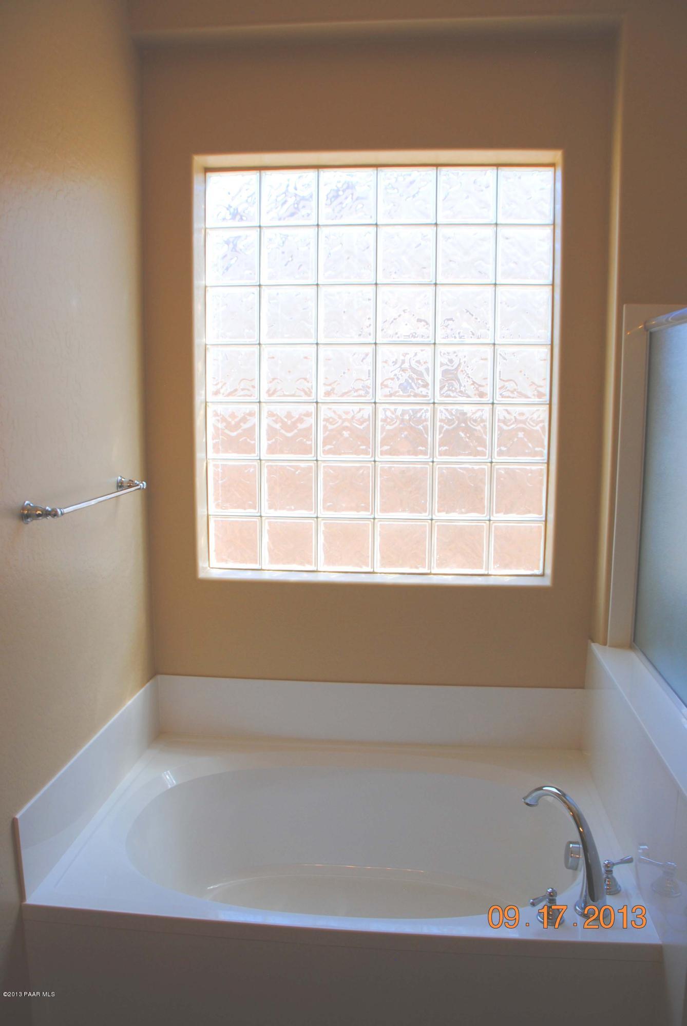 7906 East Mesteno Road Prescott Valley, AZ 86315 - Photo 14 of 24 a bathroom with a bathtub and a window