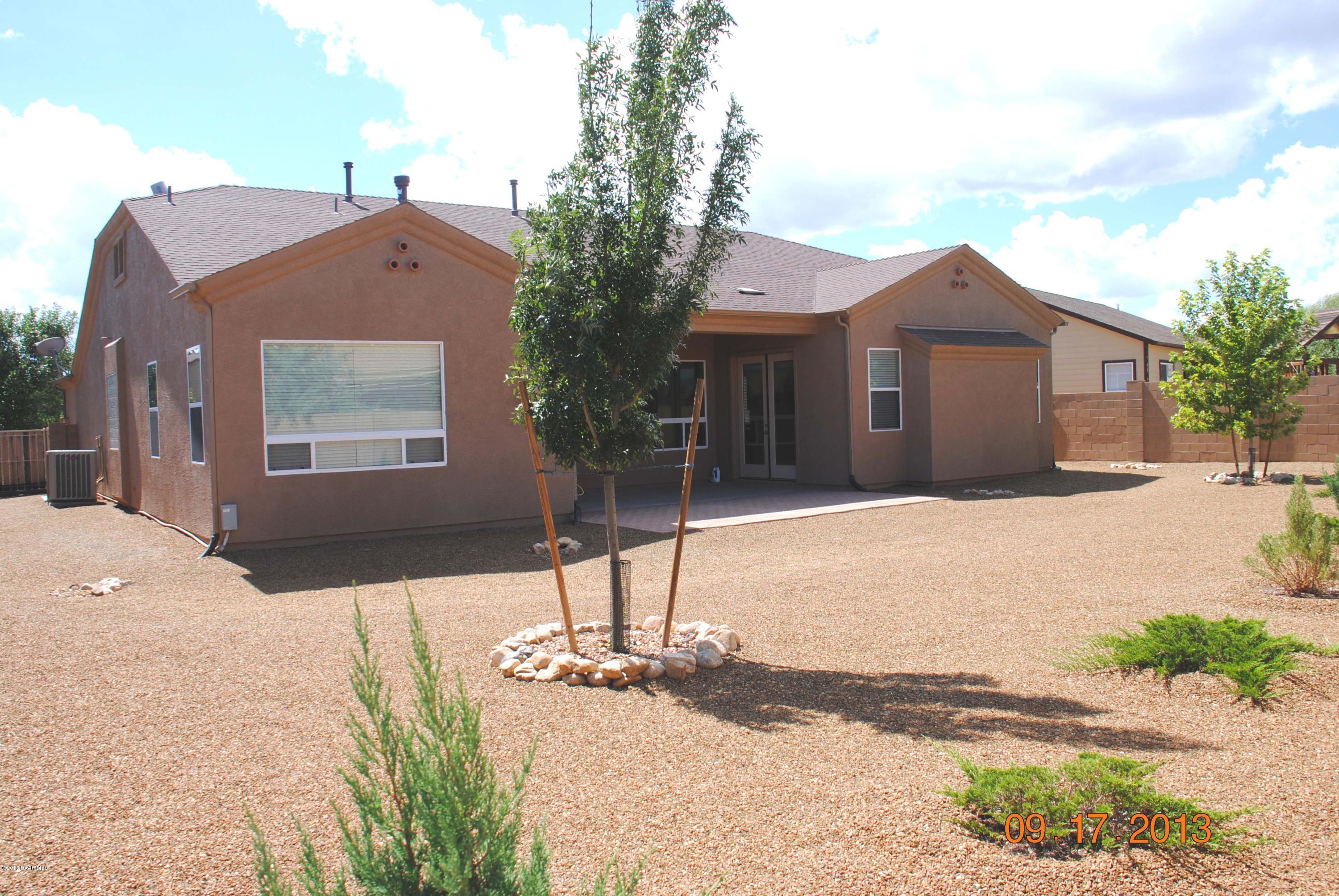 7906 East Mesteno Road Prescott Valley, AZ 86315 - Photo 21 of 24 a front view of a house with a yard and garage