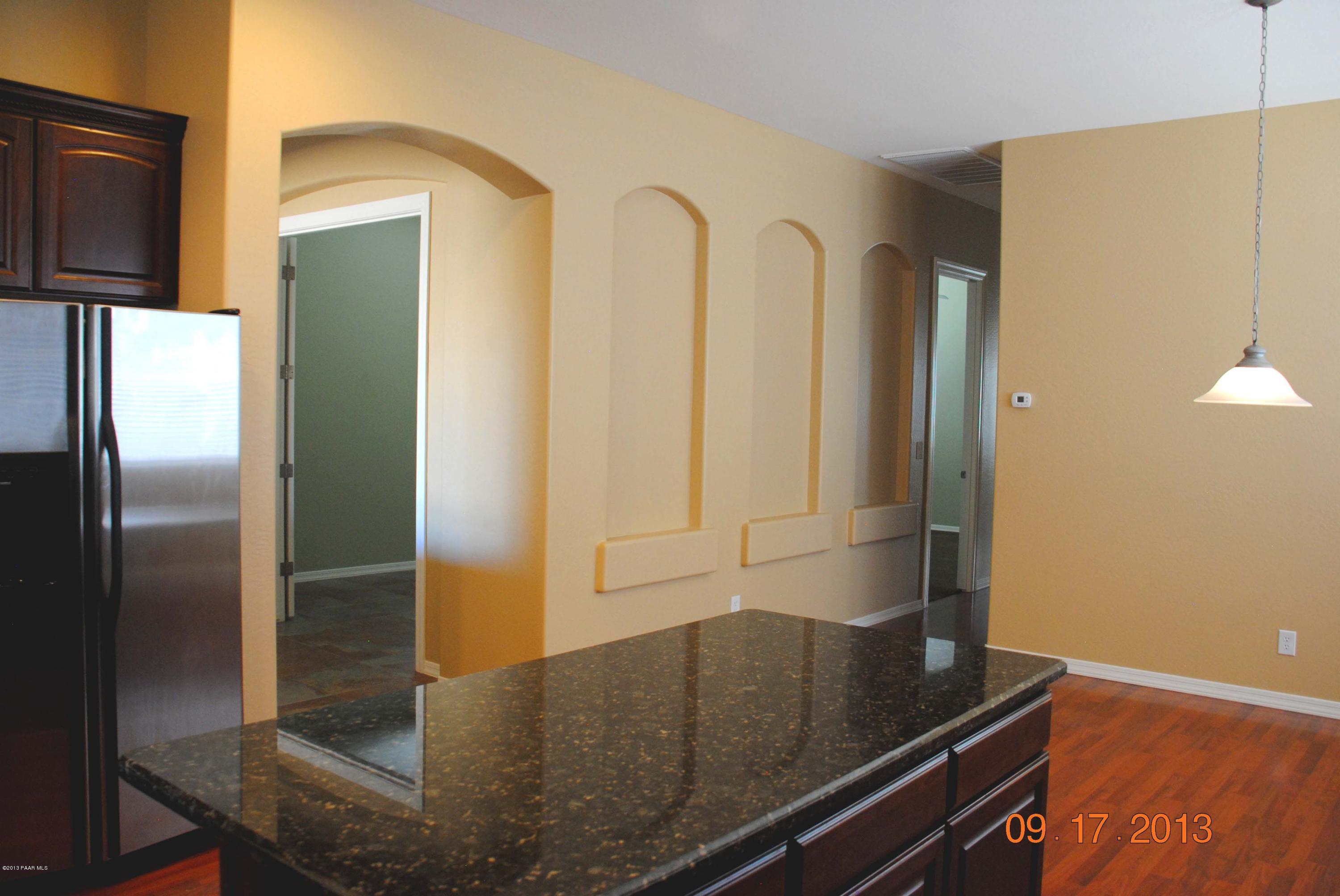 7906 East Mesteno Road Prescott Valley, AZ 86315 - Photo 5 of 24 a view of a refrigerator a sink and cabinets