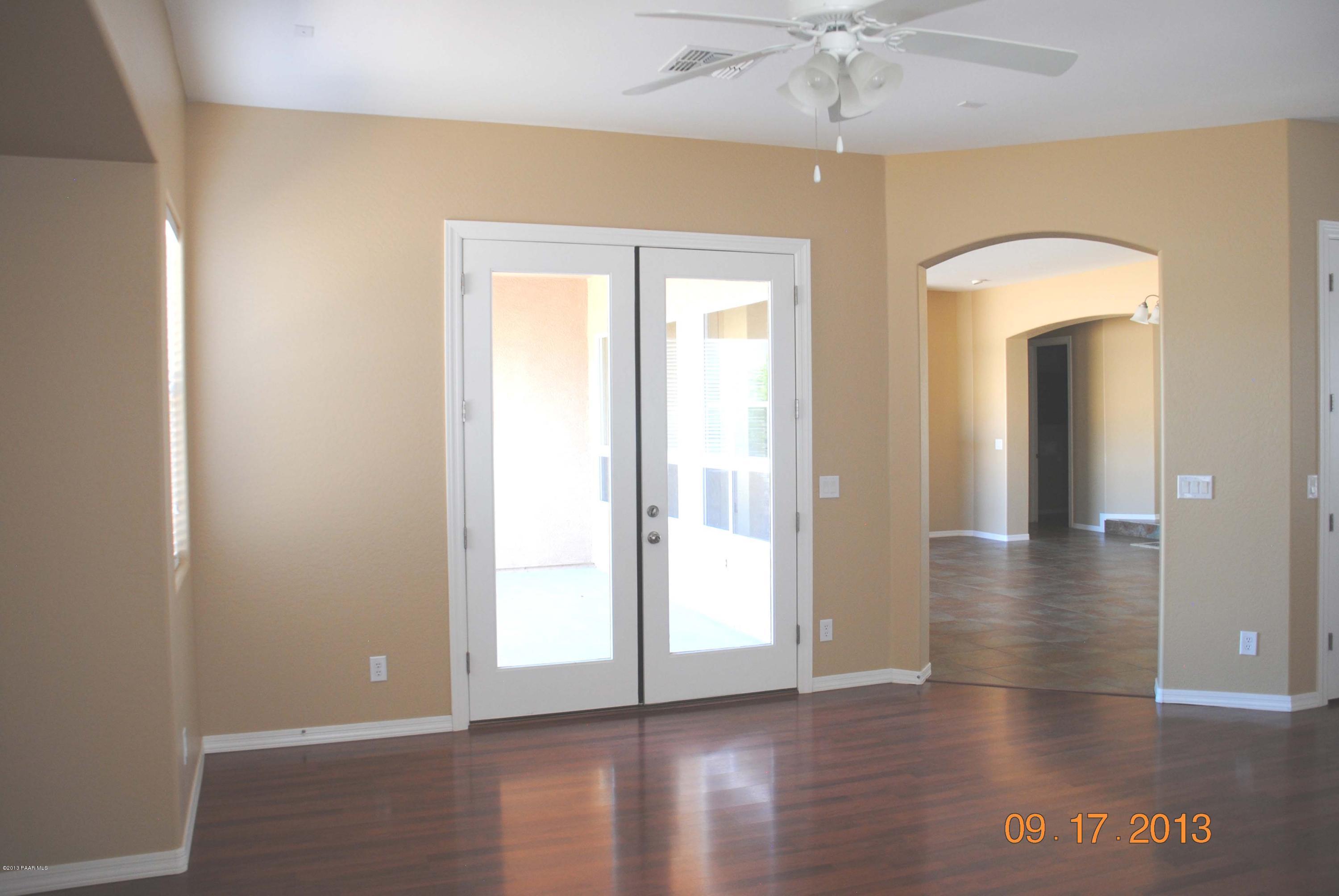 7906 East Mesteno Road Prescott Valley, AZ 86315 - Photo 9 of 24 wooden floor in an empty room with a window