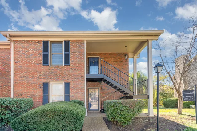 a view of a brick house with a large window
