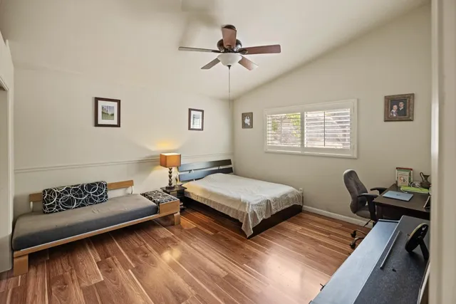 a bedroom with furniture and wooden floor