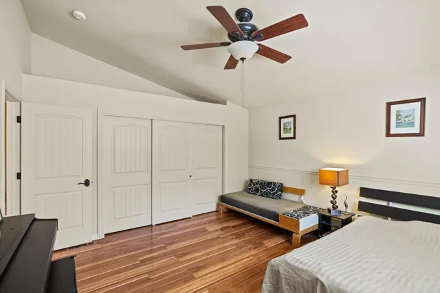 a bedroom with natural light and wooden floor