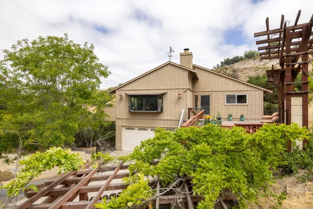 a view of a house with a wooden deck
