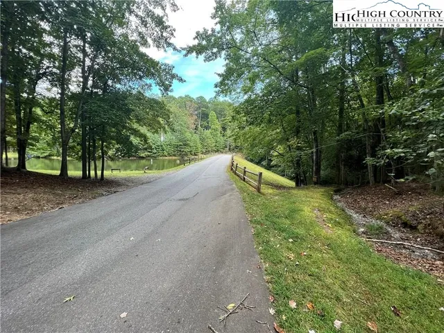 a view of a street with trees and bushes