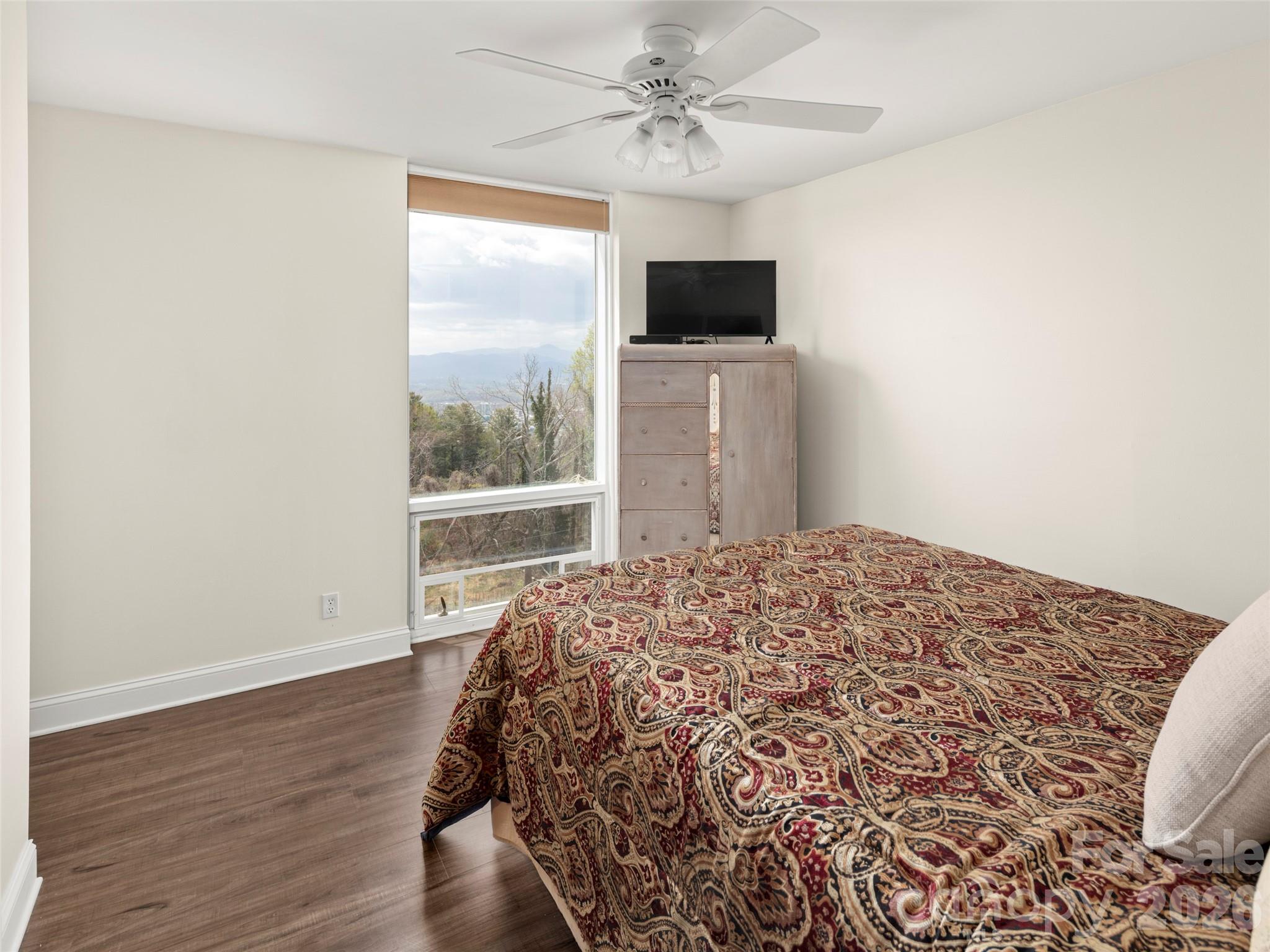 647 Town Mountain Road, Unit 612 Asheville, NC 28804 - Photo 7 of 10 a bedroom with a bed and a flat screen tv