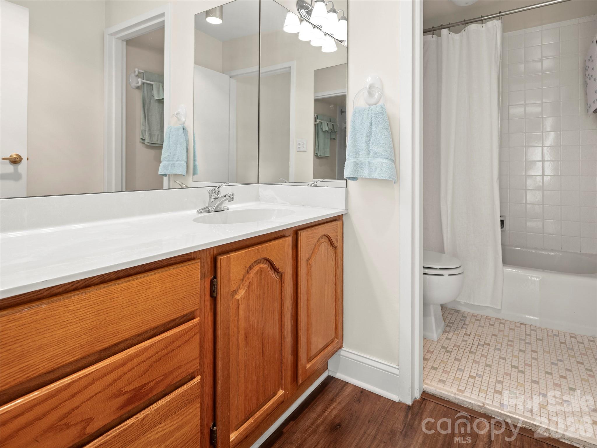 647 Town Mountain Road, Unit 612 Asheville, NC 28804 - Photo 9 of 10 a bathroom with a granite countertop sink and a mirror