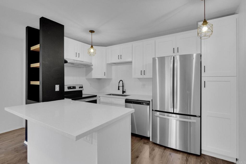 6366 Rancho Mission Road, Unit 809 San Diego, CA 92108 - Photo 1 of 1 a kitchen with stainless steel appliances a refrigerator sink and microwave