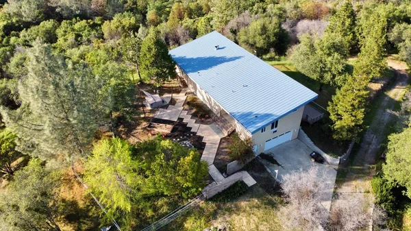 an aerial view of a house with a yard and swimming pool