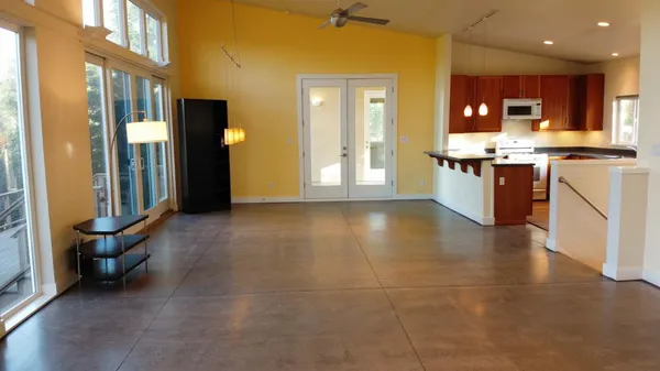 a view of kitchen with granite countertop a sink and a stove top oven