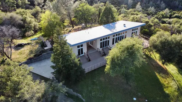 an aerial view of a house with a yard