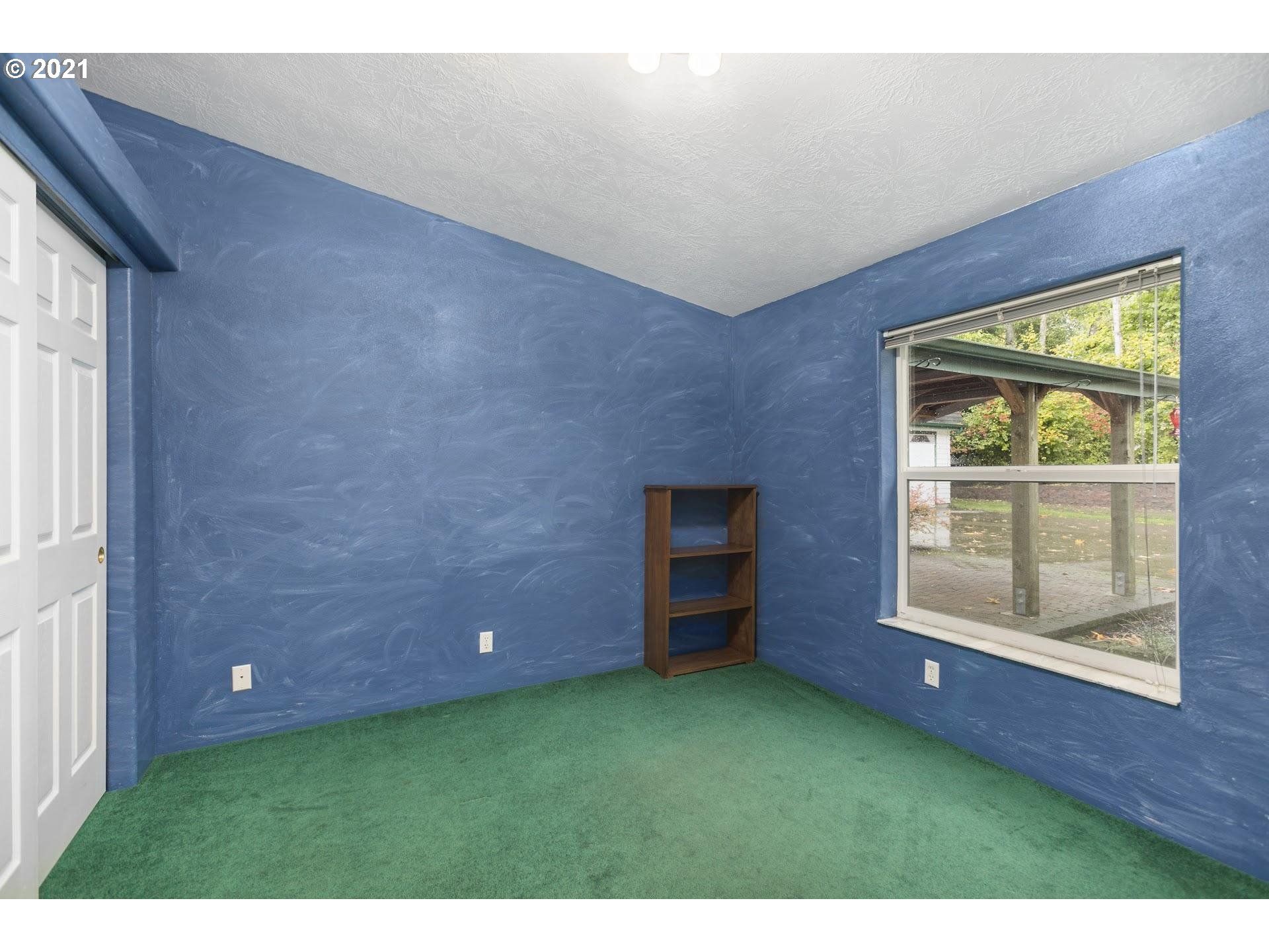 212 Northeast 253rd Street Ridgefield, WA 98642 - Photo 11 of 28 a view of an empty room with a fireplace and a window