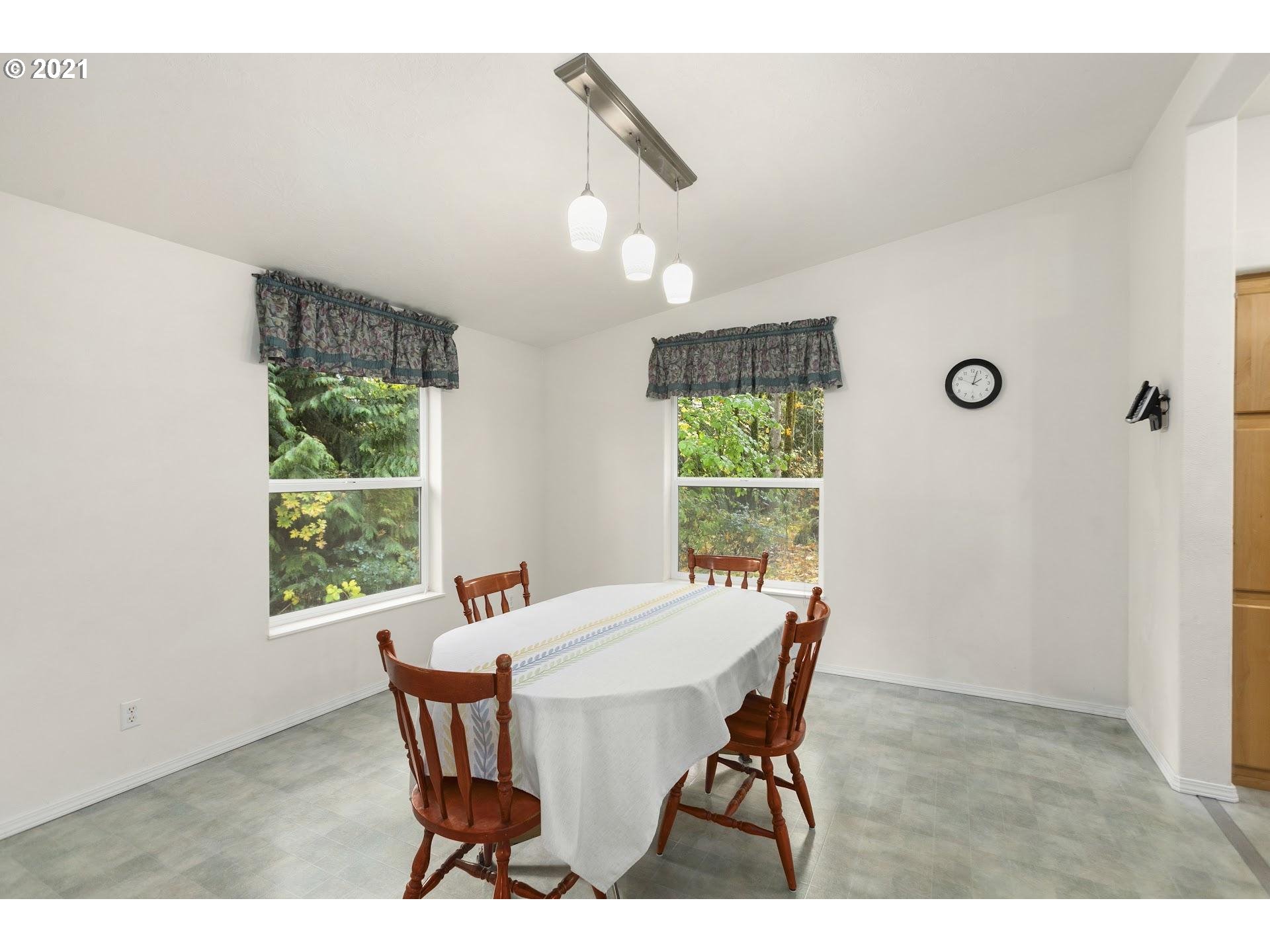 212 Northeast 253rd Street Ridgefield, WA 98642 - Photo 6 of 28 a view of a dining room with furniture window and outside view