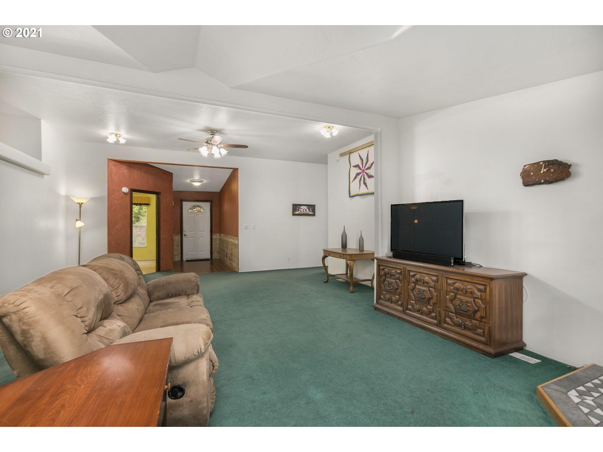 212 Northeast 253rd Street Ridgefield, WA 98642 - Photo 8 of 28 a living room with furniture and a flat screen tv