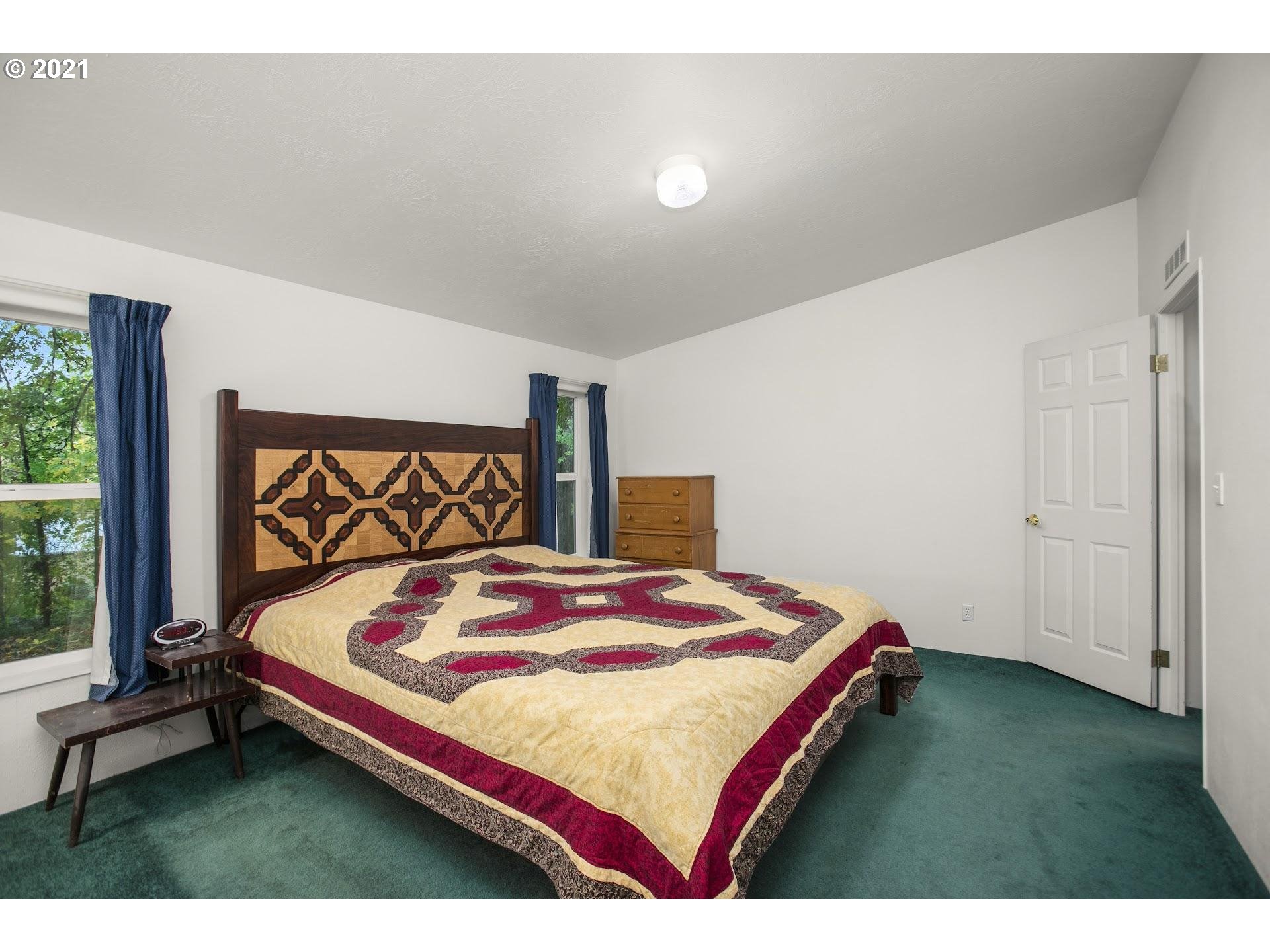 212 Northeast 253rd Street Ridgefield, WA 98642 - Photo 9 of 28 a bedroom with a bed and a dresser