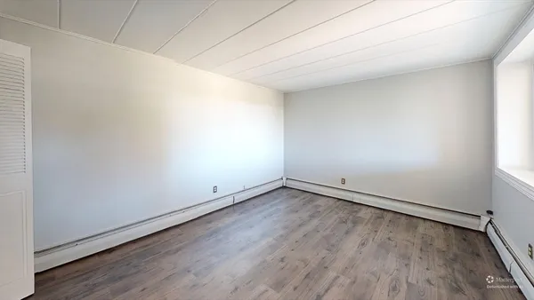 an empty room with wooden floor