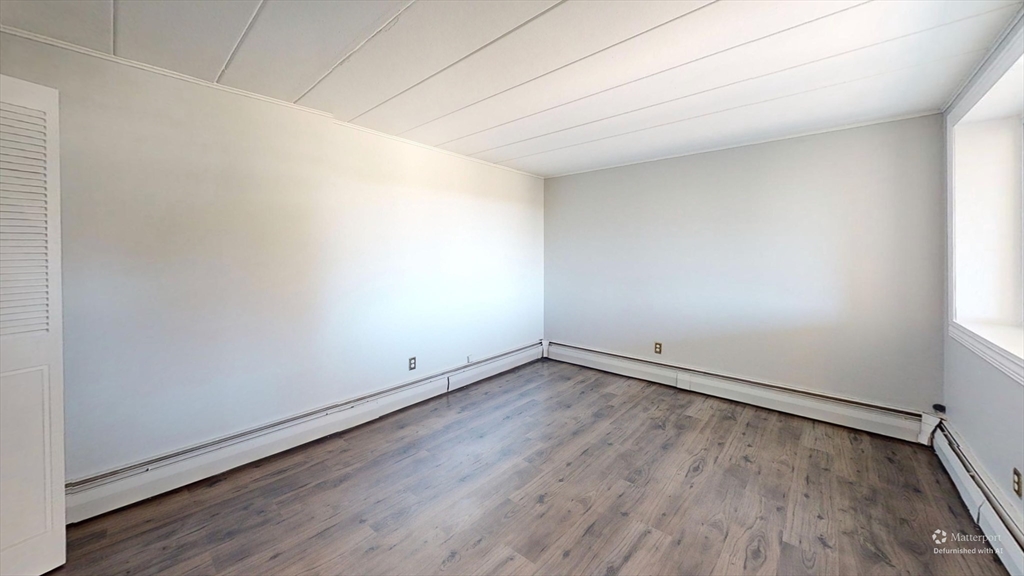 22 Nelson Drive, Unit 3E Randolph, MA 02368 - Photo 1 of 6 an empty room with wooden floor