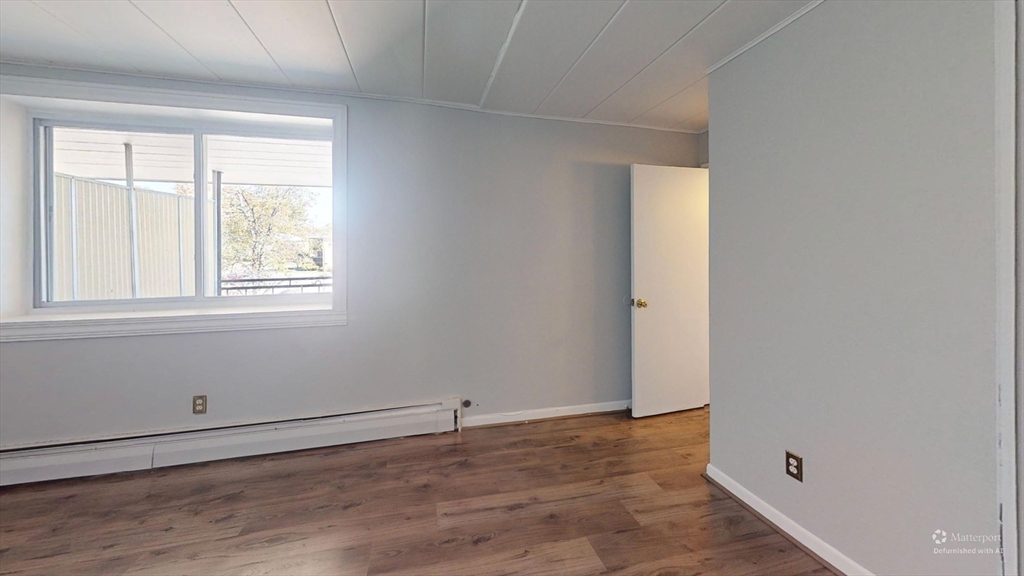 22 Nelson Drive, Unit 3E Randolph, MA 02368 - Photo 2 of 6 an empty room with a window