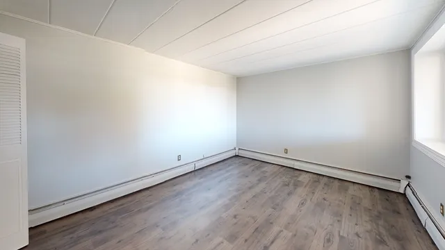 an empty room with wooden floor