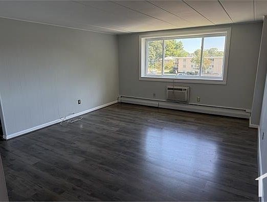 22 Nelson Drive, Unit 3E Randolph, MA 02368 - Photo 6 of 6 an empty room with wooden floor and windows