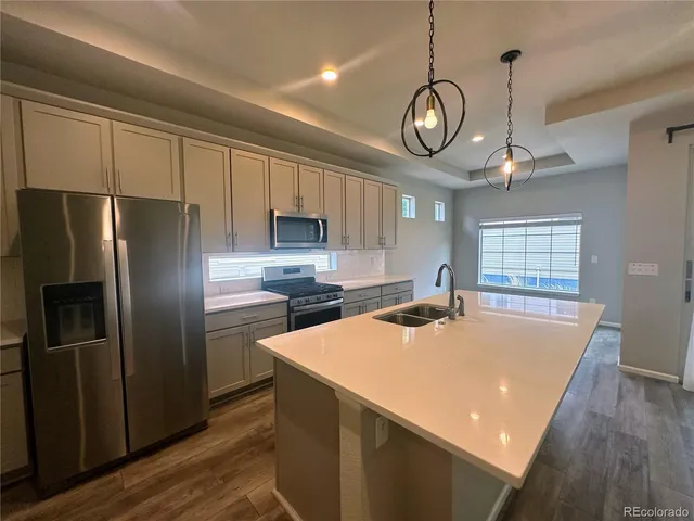 a kitchen with chandelier stainless steel appliances and a chandelier