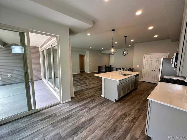 a large white kitchen with a large island oven and white cabinets