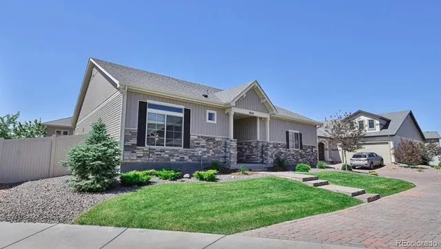 a front view of a house with a garden and plants