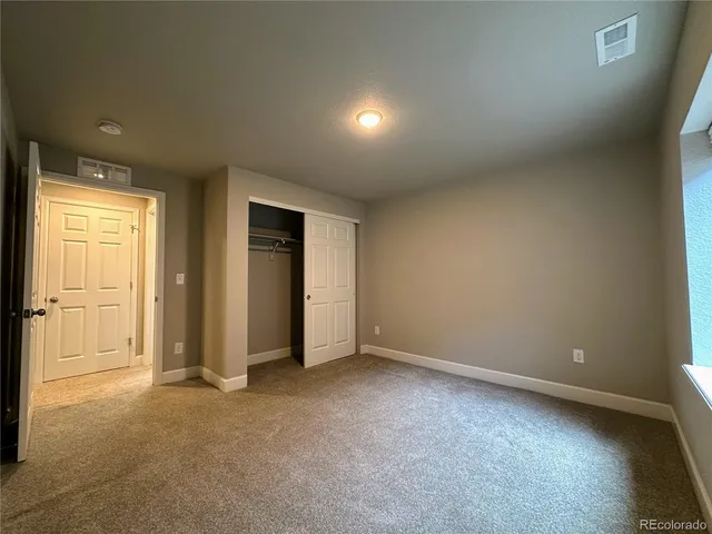 an empty room with closet area