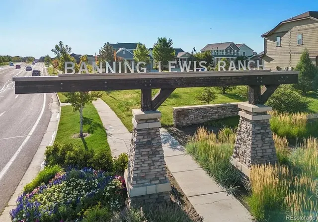 a view of a water fountain and a bench in the background