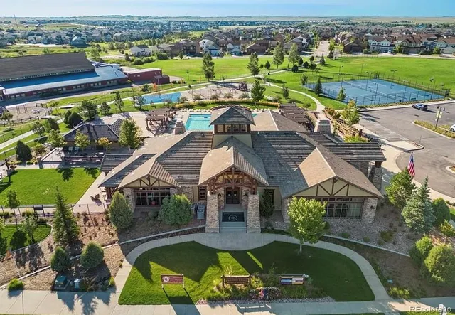 an aerial view of a house with a garden and lake view