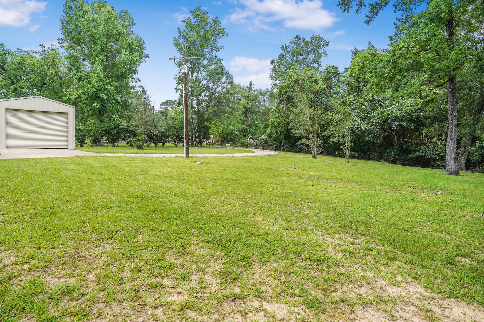 1003 Cherry Creek Road Dayton, TX 77535 - Photo 14 of 45 Long winding driveway entering the property.
