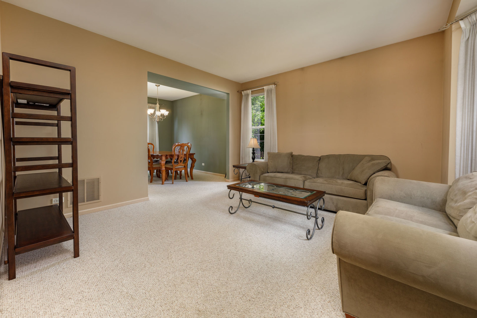 11654 Olympic Drive Plainfield, IL 60585 - Photo 11 of 25 a living room with furniture and a mirror