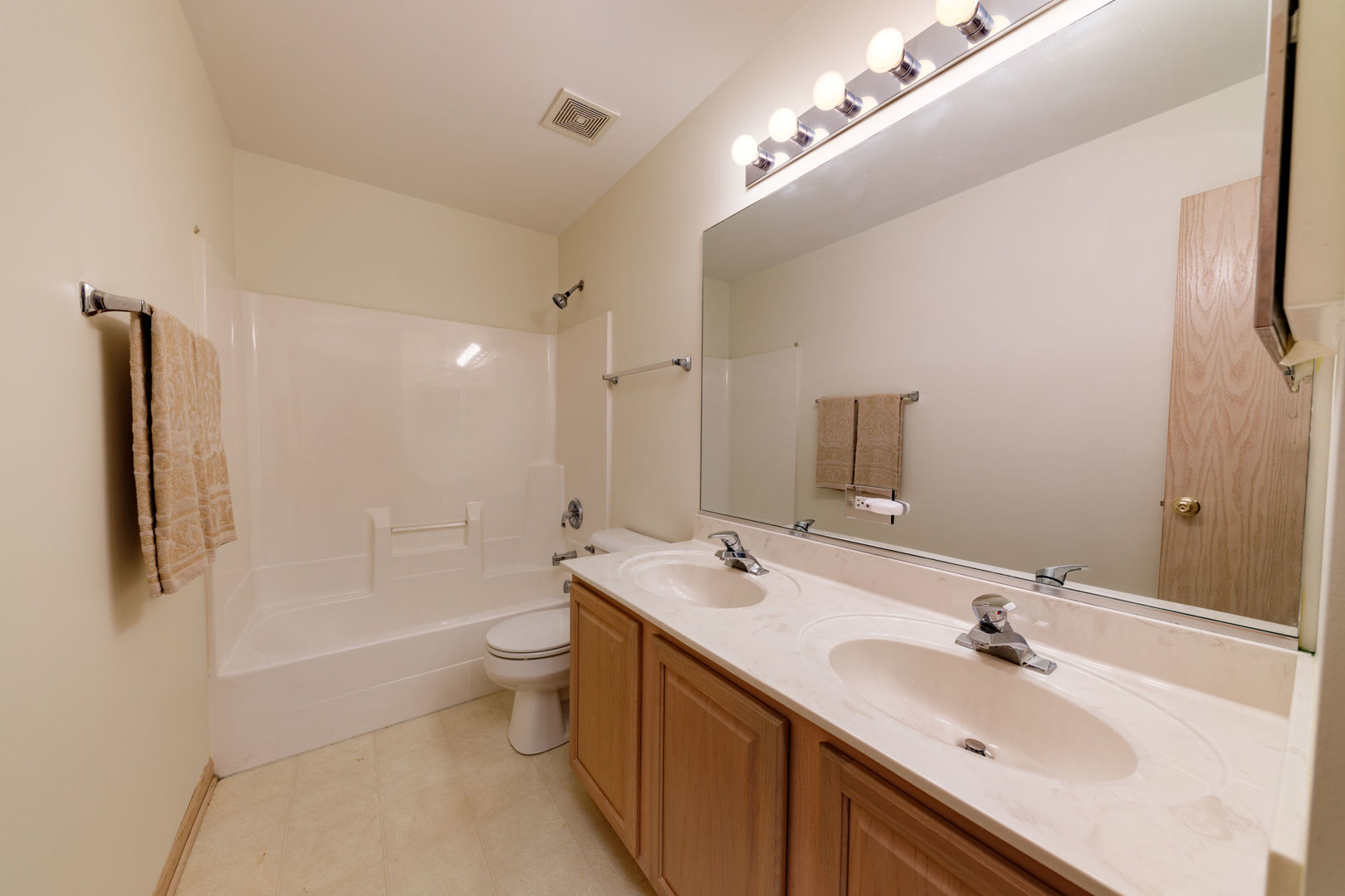 11654 Olympic Drive Plainfield, IL 60585 - Photo 20 of 25 a bathroom with a double vanity sink mirror and toilet