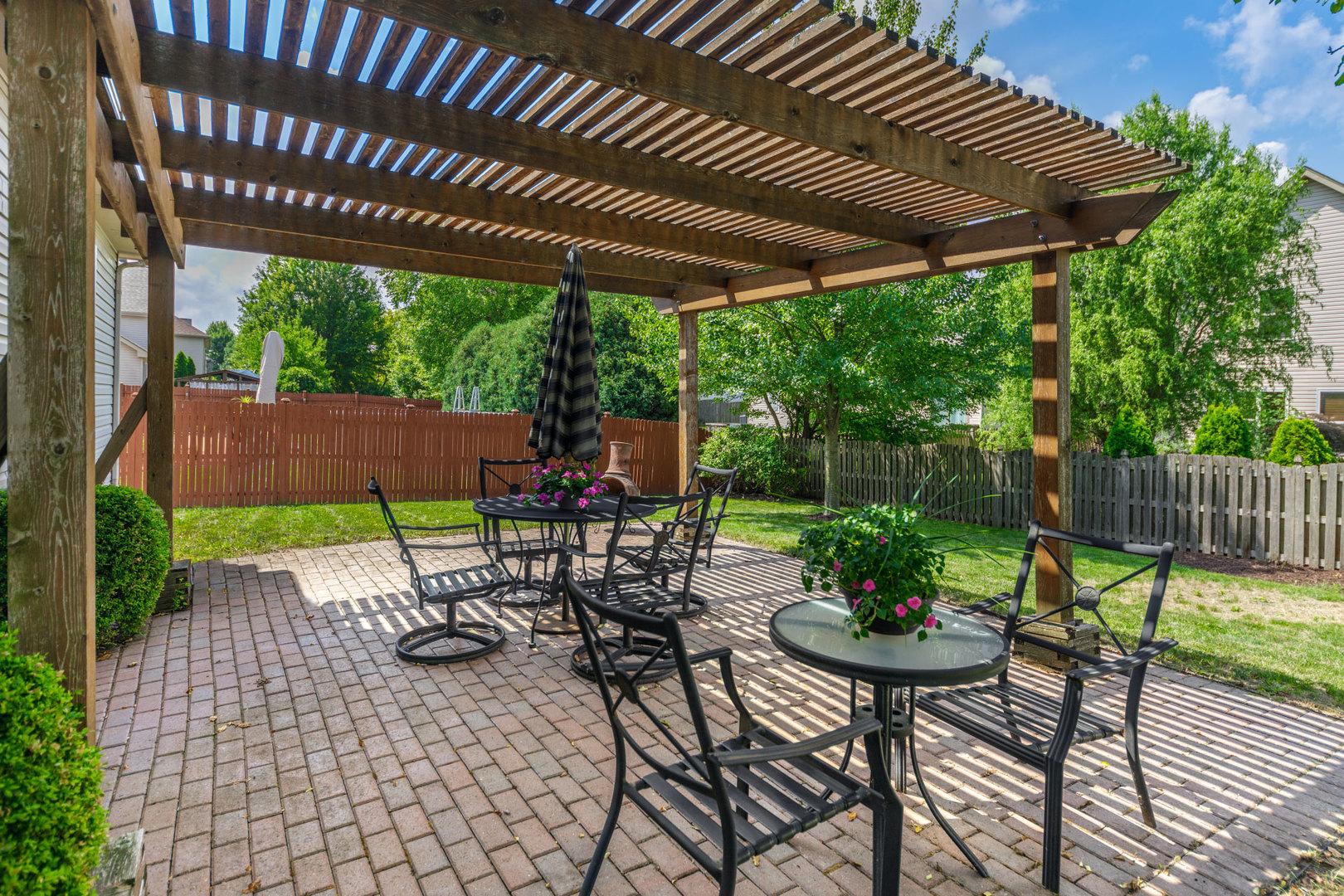 11654 Olympic Drive Plainfield, IL 60585 - Photo 24 of 25 a patio with a patio table and chairs