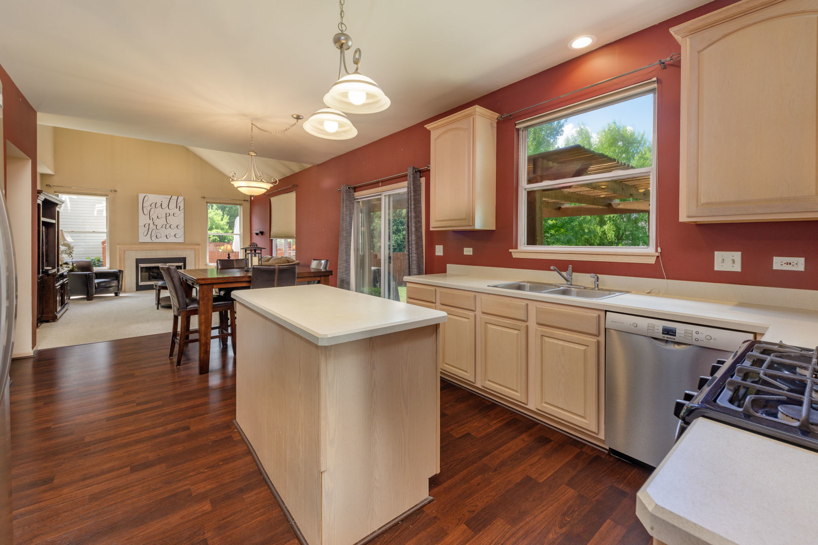 11654 Olympic Drive Plainfield, IL 60585 - Photo 6 of 25 a kitchen with a sink appliances and a counter top space