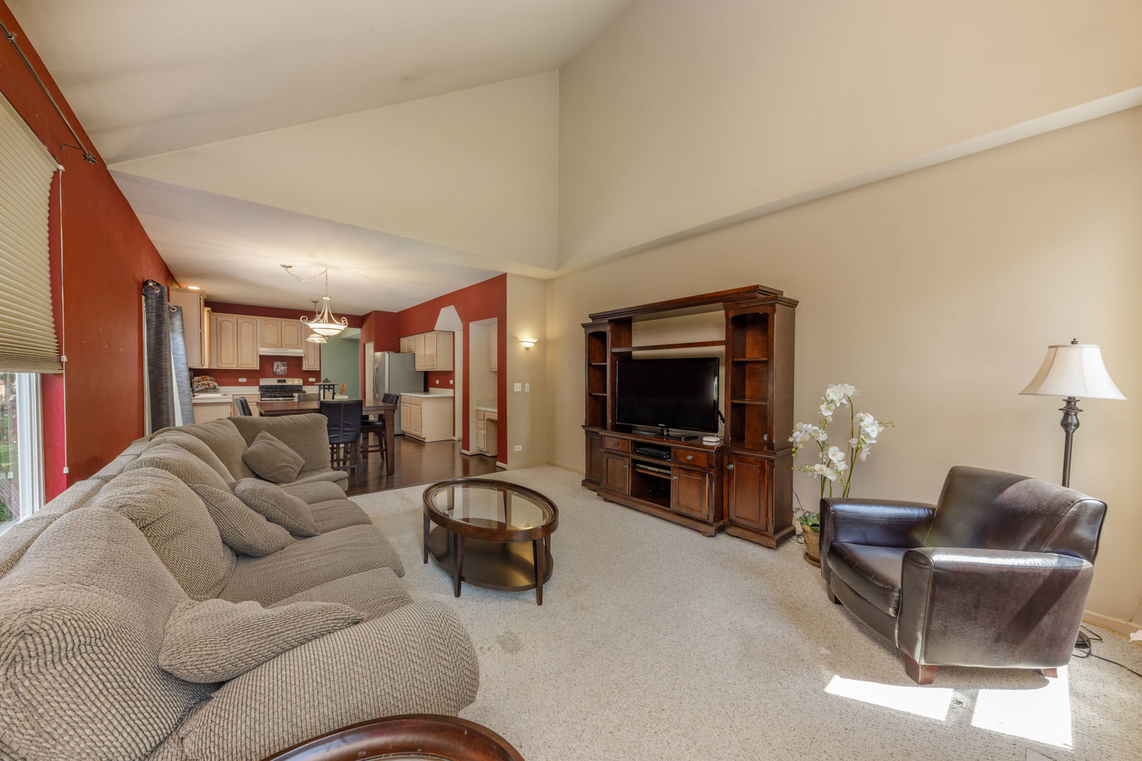 11654 Olympic Drive Plainfield, IL 60585 - Photo 9 of 25 a living room with furniture and a flat screen tv