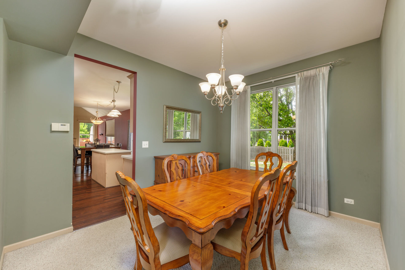 11654 Olympic Drive Plainfield, IL 60585 - Photo 10 of 25 a view of a dining room with furniture and chandelier