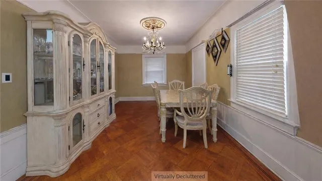 a view of a room with furniture and chandelier