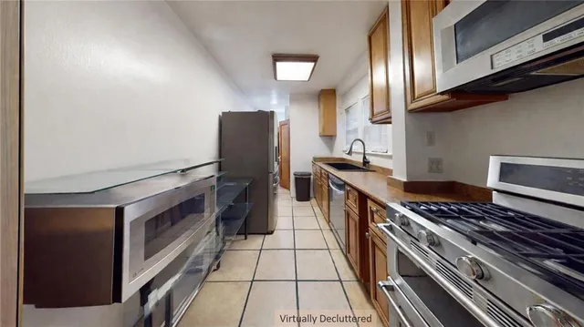 a kitchen with stainless steel appliances granite countertop a stove and a refrigerator