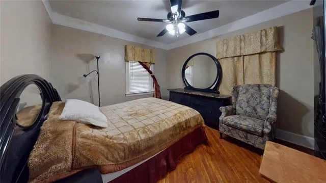 a bedroom with a bed mirror and window